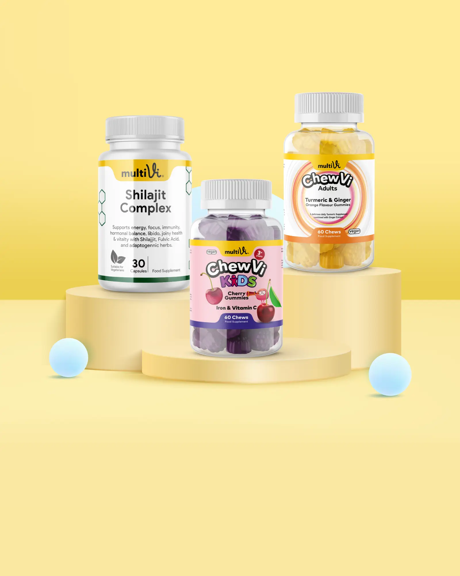 Three multivi supplement bottles sitting on tiered podium on a yellow background and blue 3d like bubble objects