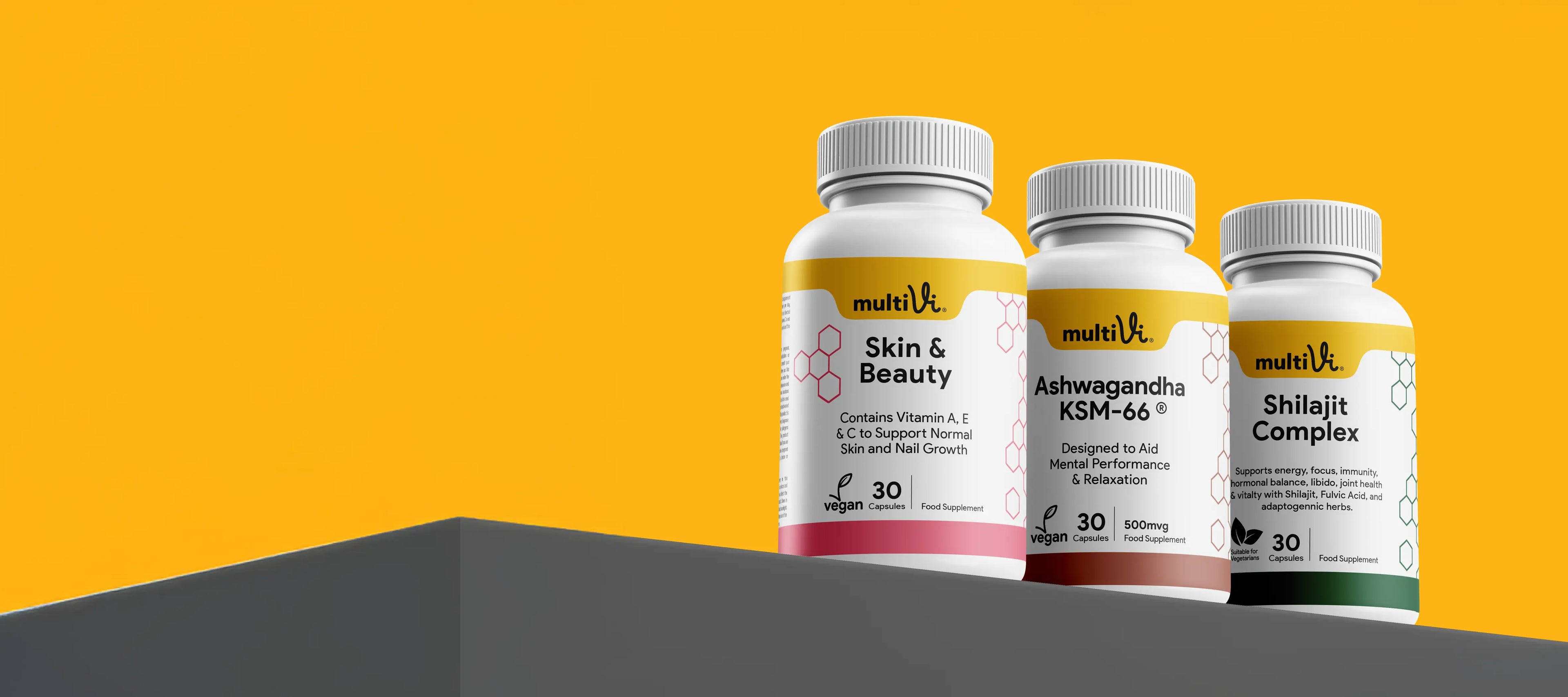 Three supplement bottles labeled 'Skin & Beauty', 'Ashwagandha KSM-66', and 'Shiitake Complex' on a yellow and gray background.
